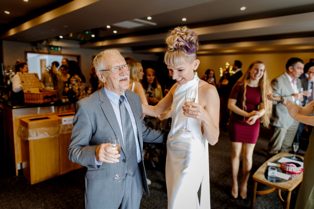 Steff and a guest chatting and laughing during their drinks reception
