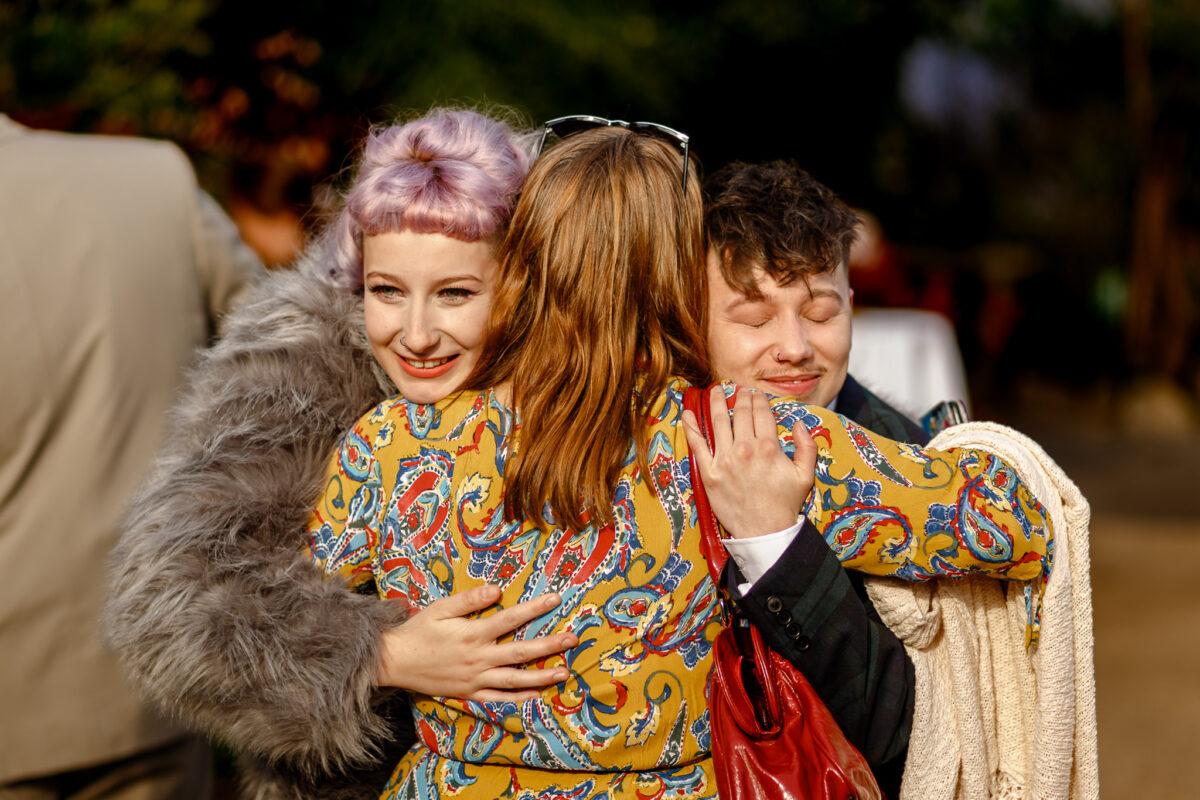 Wedding guests hugging during the celebrations