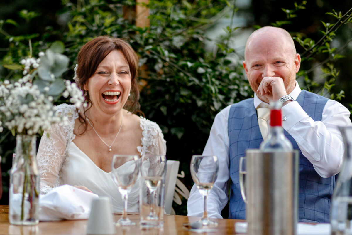 Bride and groom laughing during the reception