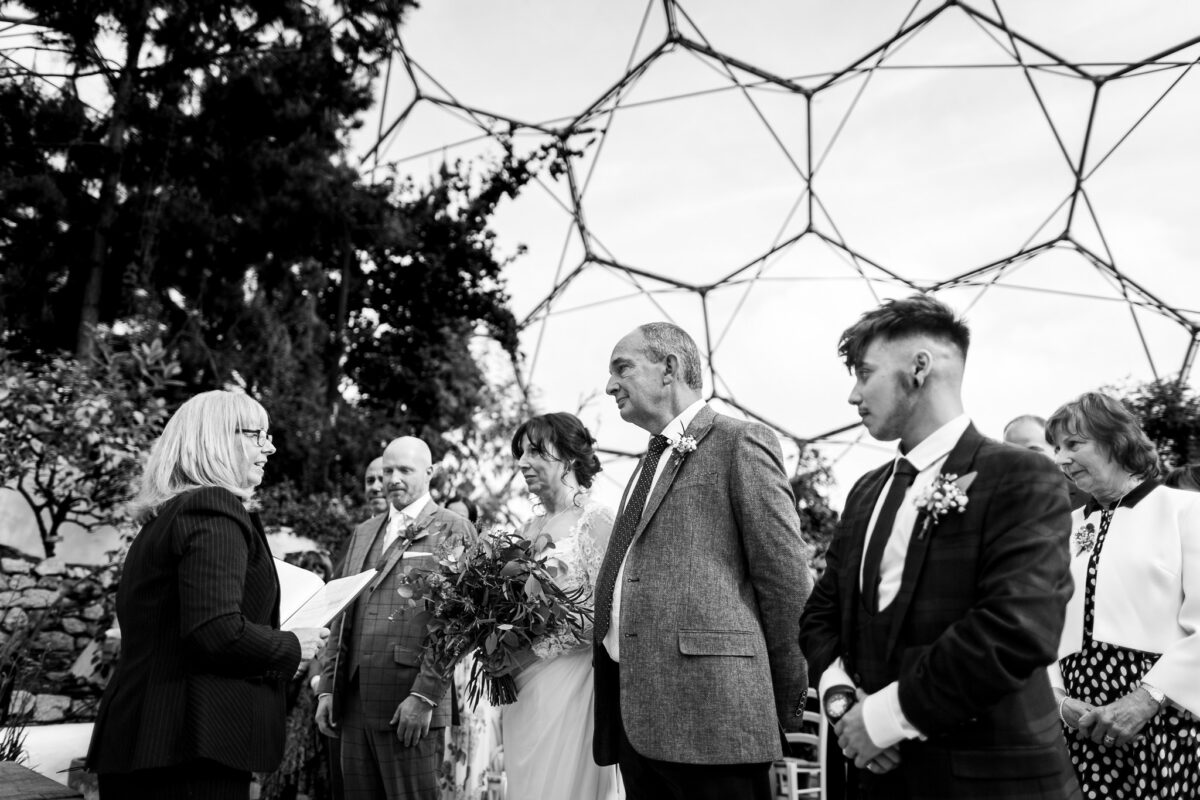 Black and white view of the Eden Project Biome's geometric glass roof during a wedding ceremony