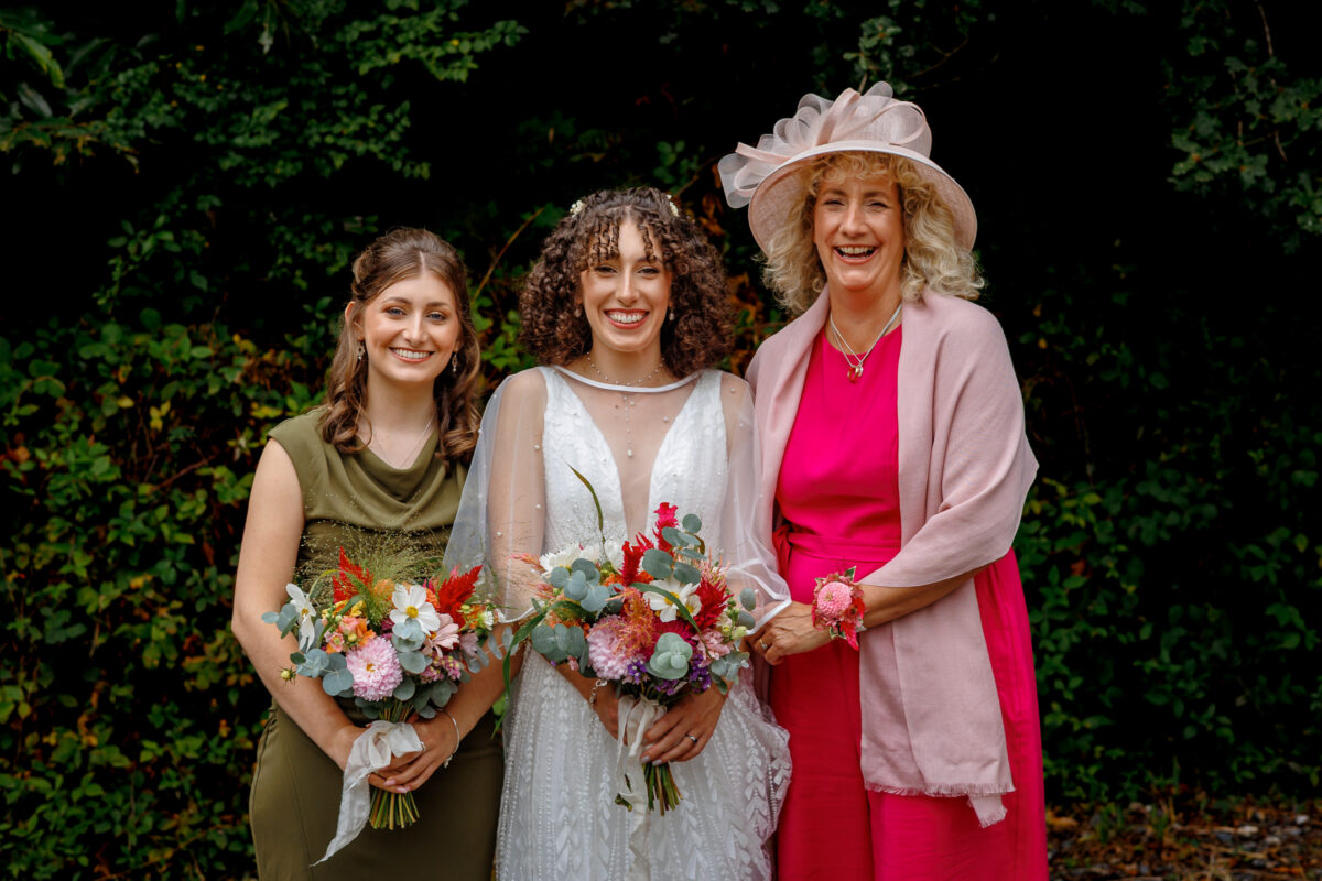 a bride with her mother and bridesmaid
