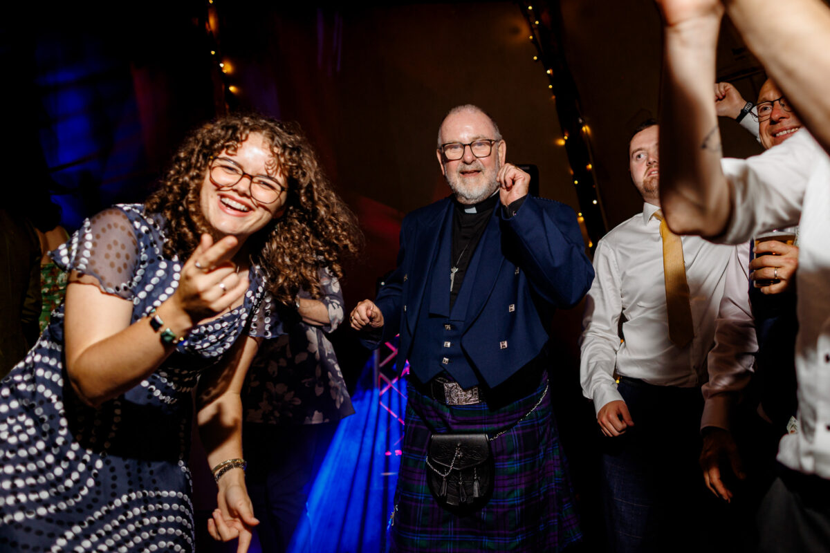 a vicar dancing at a wedding