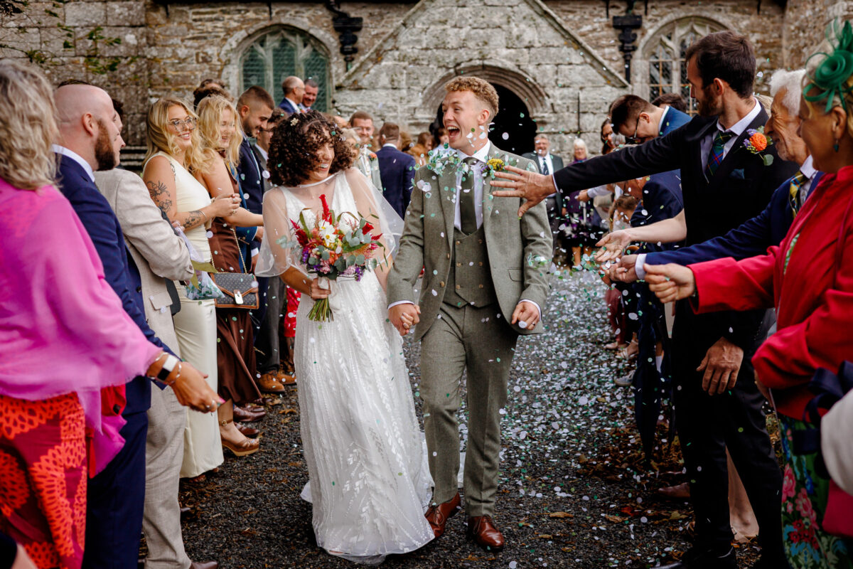 wedding confetti outside of a church in cornwall